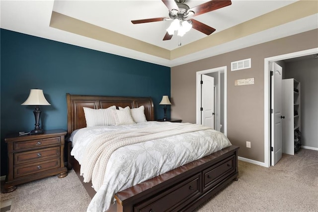 16910 Juniper Dr, Basehor, KS 66007 - bedroom with light carpet, a tray ceiling, and a ceiling fan
