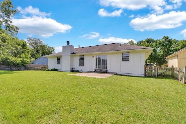 11704 E 76th Ter, Raytown, MO 64138 - rear view of house with board and batten siding, a patio, and a chimney
