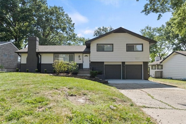 9741 Walnut St, Kansas City, MO 64114 - tri-level home featuring a garage, a front lawn, a chimney, and concrete driveway