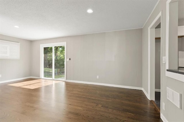 9741 Walnut St, Kansas City, MO 64114 - spare room featuring wood finished floors, a textured ceiling, and recessed lighting