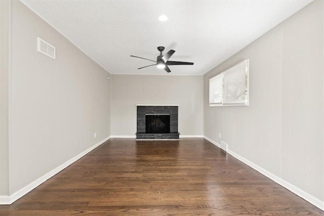9741 Walnut St, Kansas City, MO 64114 - unfurnished living room with dark wood-style flooring, a ceiling fan, and a fireplace with raised hearth