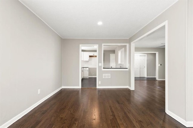 9741 Walnut St, Kansas City, MO 64114 - unfurnished living room featuring dark wood-style flooring and recessed lighting