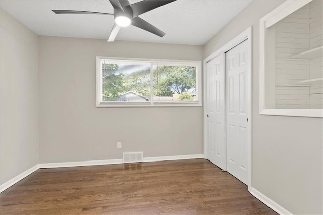 9741 Walnut St, Kansas City, MO 64114 - unfurnished bedroom with wood finished floors, a closet, and ceiling fan