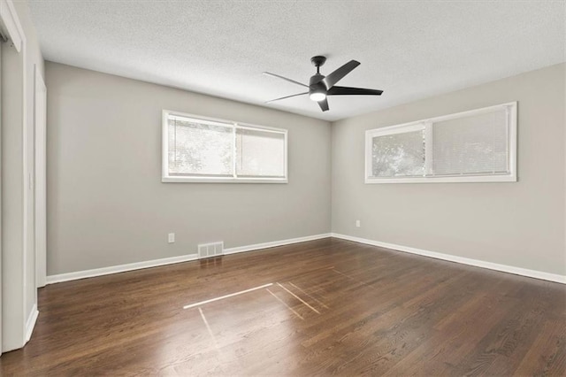 9741 Walnut St, Kansas City, MO 64114 - spare room featuring plenty of natural light, wood finished floors, and a textured ceiling