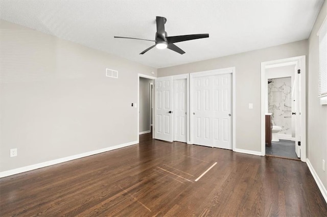 9741 Walnut St, Kansas City, MO 64114 - unfurnished bedroom featuring multiple closets, wood finished floors, connected bathroom, and ceiling fan