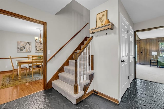 10124 Halsey St, Lenexa, KS 66215 - stairs featuring a chandelier and baseboards