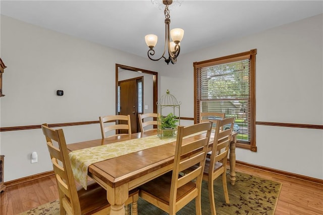 10124 Halsey St, Lenexa, KS 66215 - dining area featuring a chandelier, light wood finished floors, and baseboards