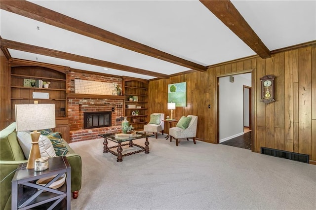 10124 Halsey St, Lenexa, KS 66215 - carpeted living room with beam ceiling, wooden walls, a fireplace, built in features, and baseboards