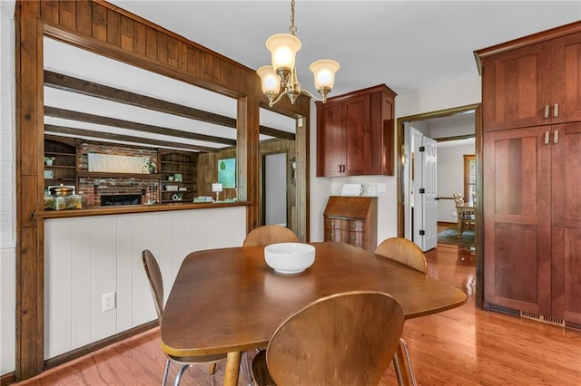 10124 Halsey St, Lenexa, KS 66215 - dining room with light wood-style flooring and a chandelier