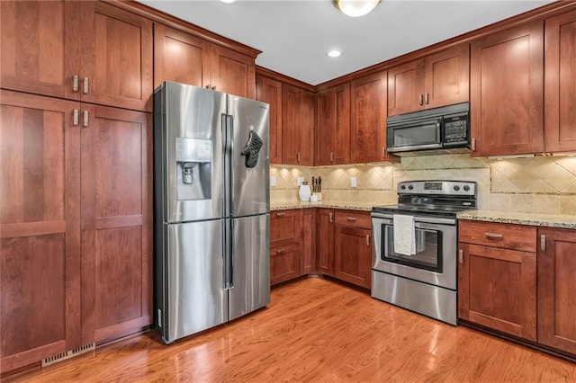 10124 Halsey St, Lenexa, KS 66215 - kitchen with appliances with stainless steel finishes, light stone counters, backsplash, light wood-type flooring, and recessed lighting