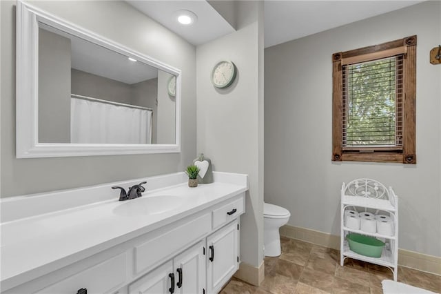 10124 Halsey St, Lenexa, KS 66215 - bathroom with vanity, toilet, and baseboards