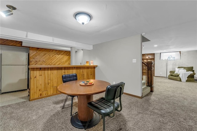 10124 Halsey St, Lenexa, KS 66215 - carpeted dining area with a bar, wood walls, baseboards, and stairway