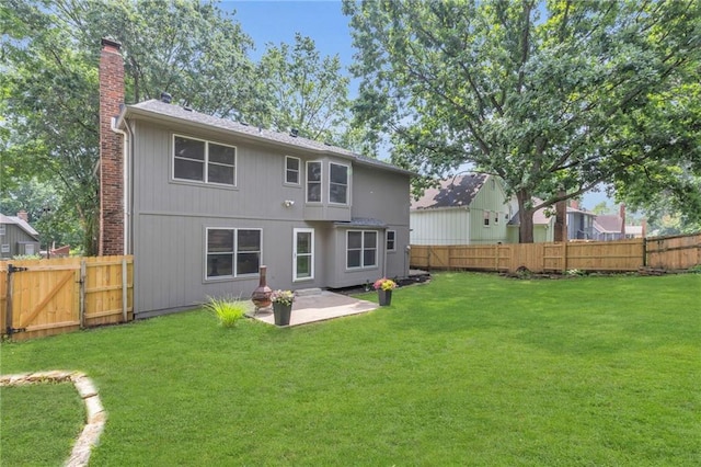 10124 Halsey St, Lenexa, KS 66215 - rear view of house with a chimney, a patio area, and a gate