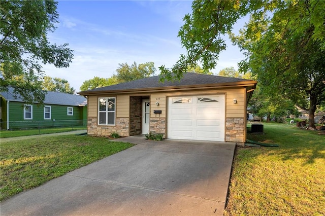739 S Cypress St, Ottawa, KS 66067 - ranch-style home featuring stone siding, concrete driveway, and a garage
