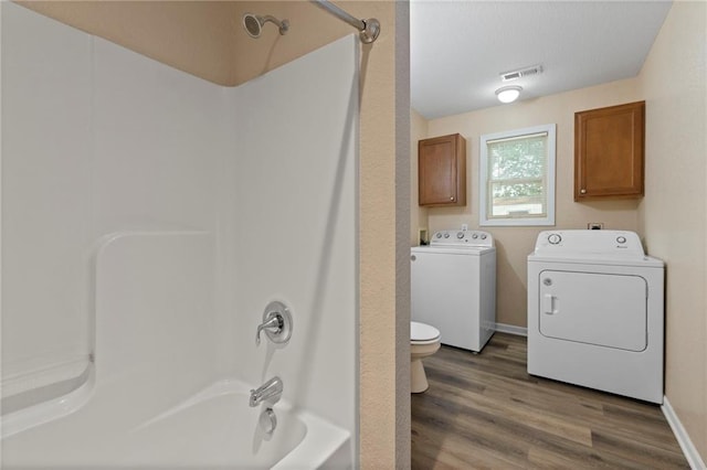 739 S Cypress St, Ottawa, KS 66067 - full bathroom with washer and dryer, tub / shower combination, and wood finished floors