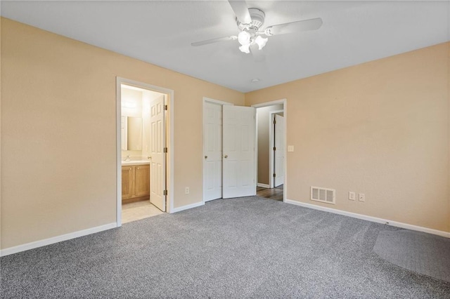 739 S Cypress St, Ottawa, KS 66067 - unfurnished bedroom with carpet, ensuite bath, and a ceiling fan