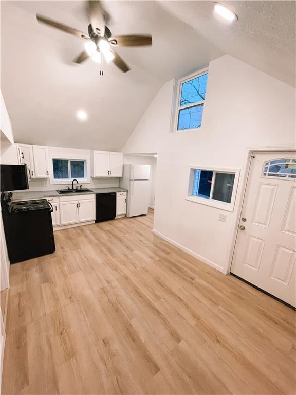 8633 N Main St, Kansas City, MO 64155 - kitchen featuring black appliances, a sink, white cabinetry, a ceiling fan, and vaulted ceiling