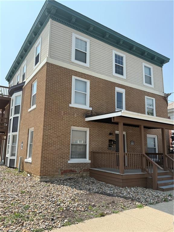 106 Saratoga St, Excelsior Springs, MO 64024 - view of front of property with brick siding and covered porch
