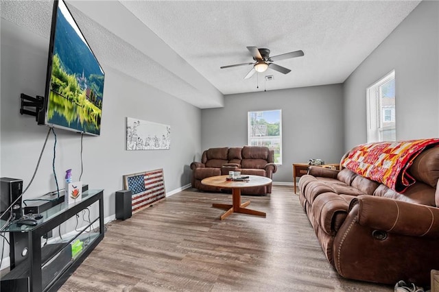 106 Saratoga St, Excelsior Springs, MO 64024 - living area with a textured ceiling, a ceiling fan, and wood finished floors