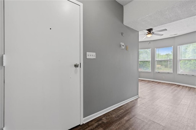 106 Saratoga St, Excelsior Springs, MO 64024 - corridor featuring wood finished floors and a textured ceiling