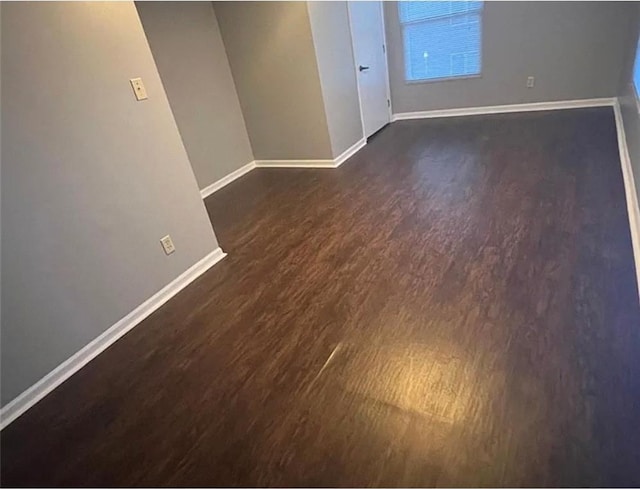 106 Saratoga St, Excelsior Springs, MO 64024 - empty room featuring baseboards and dark wood finished floors