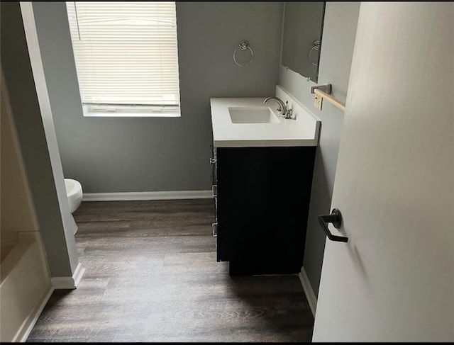 106 Saratoga St, Excelsior Springs, MO 64024 - bathroom with wood finished floors, vanity, and a tub to relax in