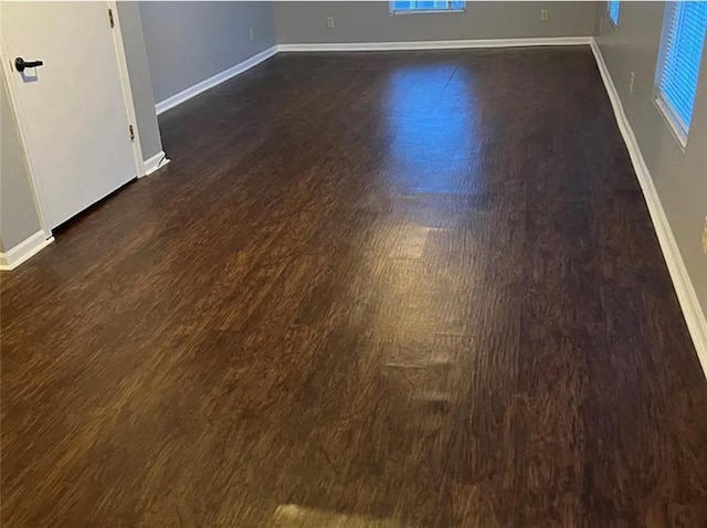 106 Saratoga St, Excelsior Springs, MO 64024 - spare room with dark wood-type flooring and baseboards