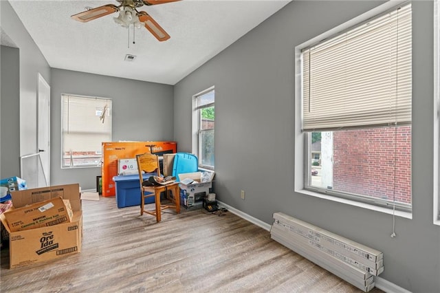 106 Saratoga St, Excelsior Springs, MO 64024 - living area featuring wood finished floors and ceiling fan