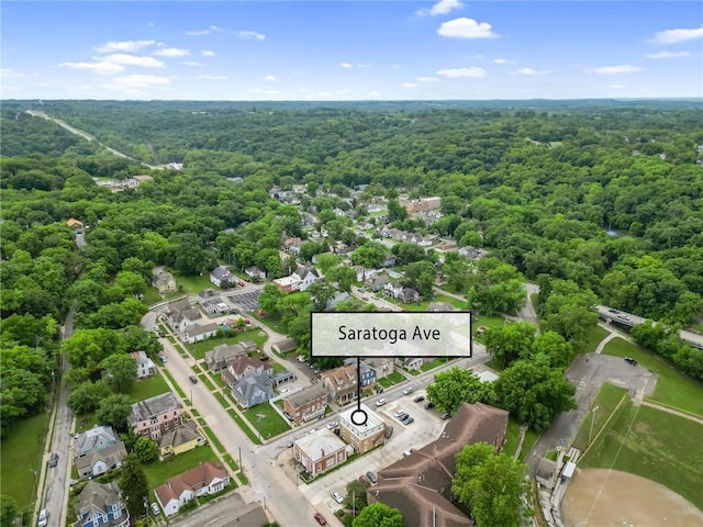 106 Saratoga St, Excelsior Springs, MO 64024 - aerial view of property and surrounding area featuring a heavily wooded area