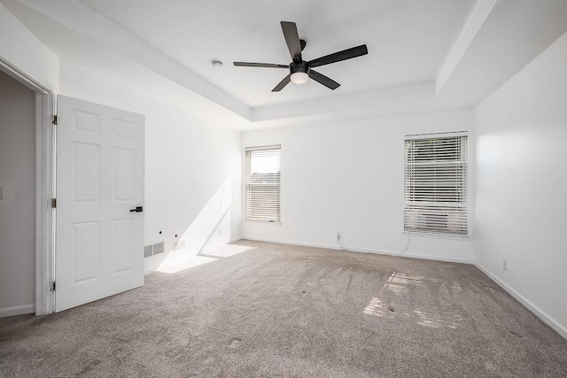 12655 S Clinton St, Olathe, KS 66061 - unfurnished bedroom with a tray ceiling, carpet, baseboards, and ceiling fan