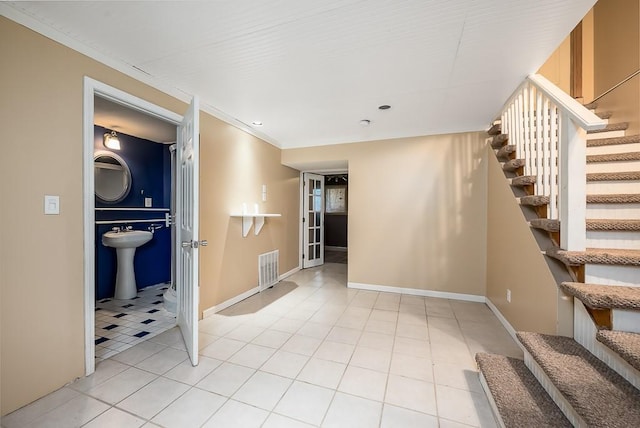 12655 S Clinton St, Olathe, KS 66061 - unfurnished room featuring stairs, light tile patterned flooring, a sink, baseboards, and ornamental molding