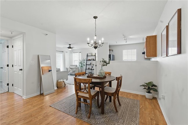 5610 NE 80th Ter Unit 1D, Kansas City, MO 64119 - dining space featuring a chandelier, light wood finished floors, baseboards, and ceiling fan