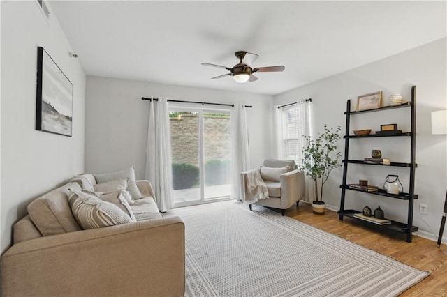 5610 NE 80th Ter Unit 1D, Kansas City, MO 64119 - living room featuring ceiling fan, wood finished floors, and baseboards
