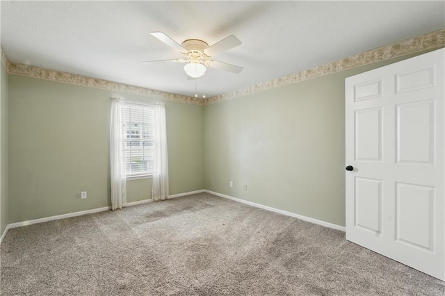 5610 NE 80th Ter Unit 1D, Kansas City, MO 64119 - spare room featuring carpet floors, ceiling fan, and baseboards