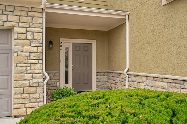 16059 Fontana St Unit 204, Overland Park, KS 66085 - view of exterior entry with stucco siding and stone siding