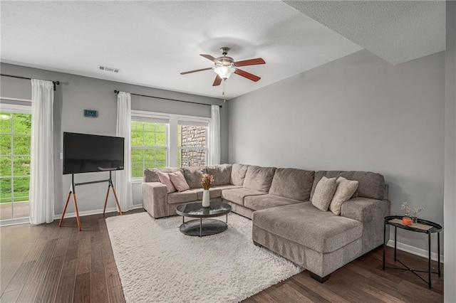16059 Fontana St Unit 204, Overland Park, KS 66085 - living room with dark wood-style flooring, ceiling fan, baseboards, and a textured ceiling