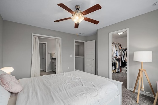 16059 Fontana St Unit 204, Overland Park, KS 66085 - bedroom featuring a spacious closet, a closet, baseboards, carpet floors, and ceiling fan
