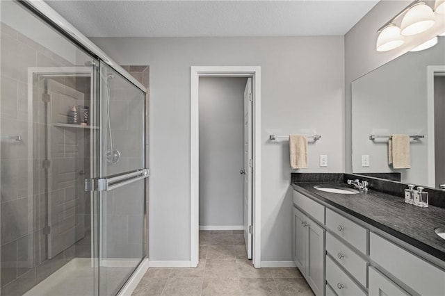 16059 Fontana St Unit 204, Overland Park, KS 66085 - full bath with double vanity, a shower stall, tile patterned flooring, and baseboards