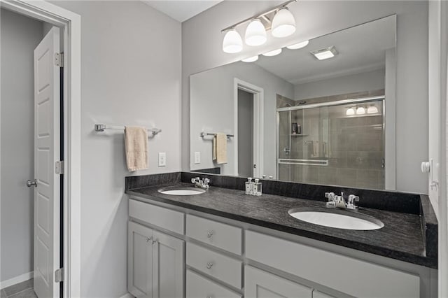 16059 Fontana St Unit 204, Overland Park, KS 66085 - full bathroom featuring double vanity, a stall shower, and baseboards