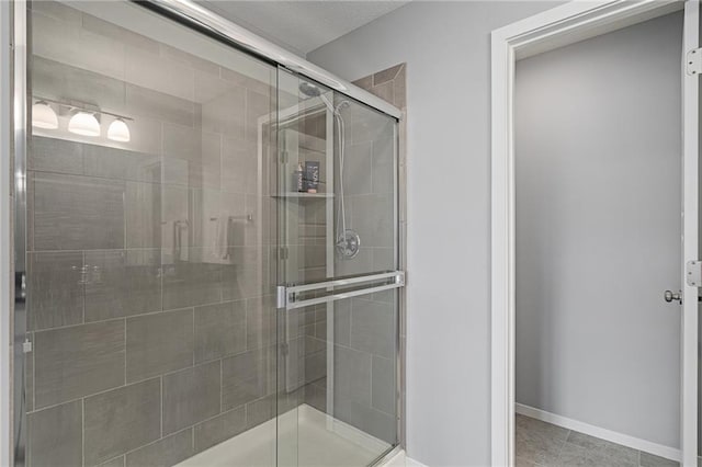 16059 Fontana St Unit 204, Overland Park, KS 66085 - bathroom featuring a shower stall, tile patterned flooring, and baseboards