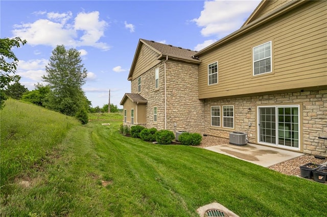 16059 Fontana St Unit 204, Overland Park, KS 66085 - rear view of property with stone siding, a lawn, a patio, and central AC