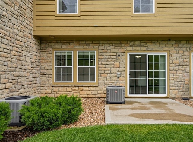 16059 Fontana St Unit 204, Overland Park, KS 66085 - property entrance with central AC unit and stone siding