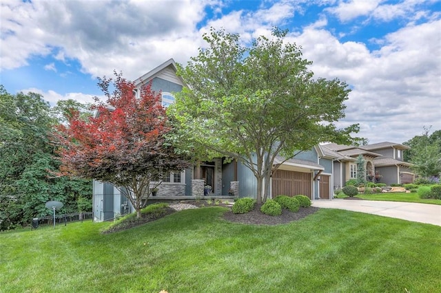 14095 NW 60th Ct, Parkville, MO 64152 - obstructed view of property with concrete driveway, an attached garage, a front yard, and stone siding