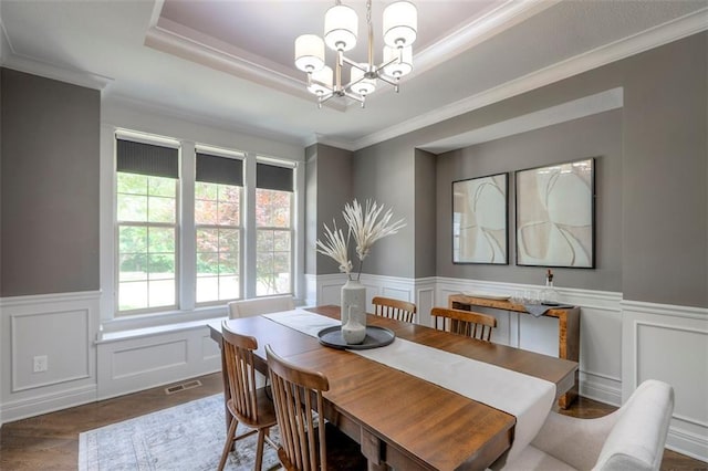 14095 NW 60th Ct, Parkville, MO 64152 - dining space with a chandelier, a tray ceiling, a decorative wall, wainscoting, and dark wood finished floors