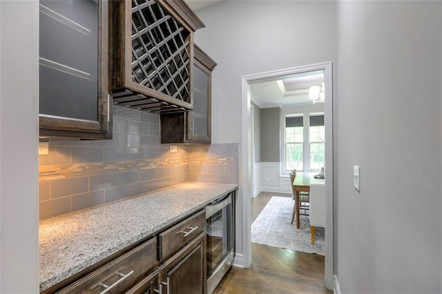 14095 NW 60th Ct, Parkville, MO 64152 - kitchen with beverage cooler, dark wood finished floors, decorative backsplash, dark brown cabinetry, and light stone counters