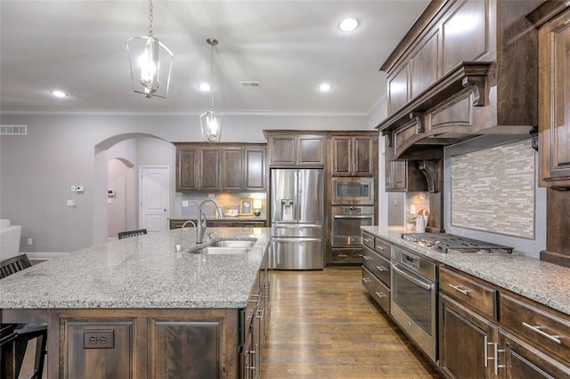 14095 NW 60th Ct, Parkville, MO 64152 - kitchen featuring stainless steel appliances, arched walkways, crown molding, tasteful backsplash, and light stone counters