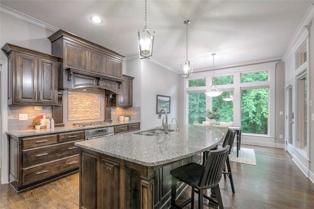14095 NW 60th Ct, Parkville, MO 64152 - kitchen featuring ornamental molding, light stone counters, tasteful backsplash, a center island with sink, and dark wood-style floors