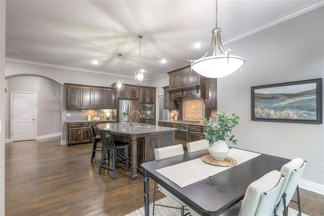 14095 NW 60th Ct, Parkville, MO 64152 - dining space featuring recessed lighting, dark wood finished floors, arched walkways, and crown molding