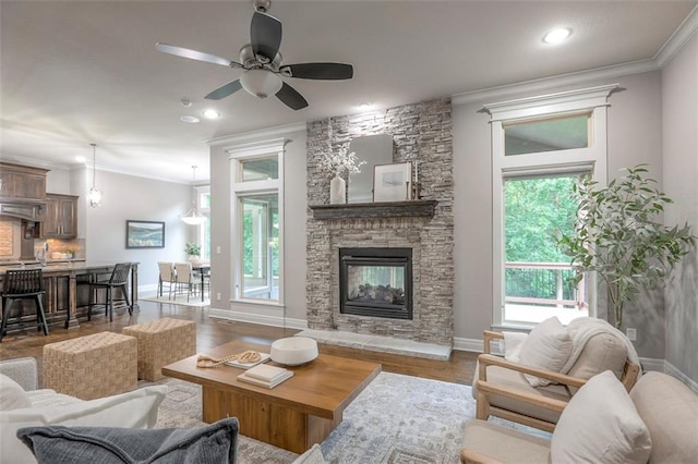 14095 NW 60th Ct, Parkville, MO 64152 - living room featuring crown molding, a fireplace, a ceiling fan, recessed lighting, and wood finished floors