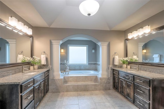 14095 NW 60th Ct, Parkville, MO 64152 - bathroom with two vanities, a bath, ornate columns, tile patterned flooring, and lofted ceiling
